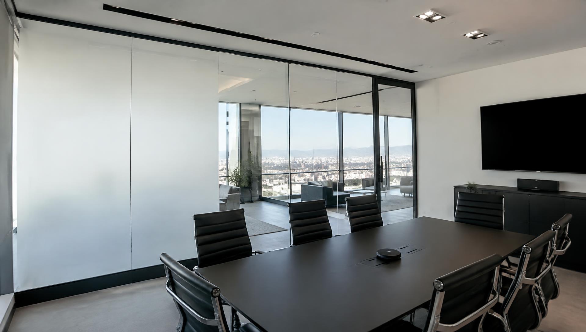 Glass partition showing smart film in both frosted and clear states